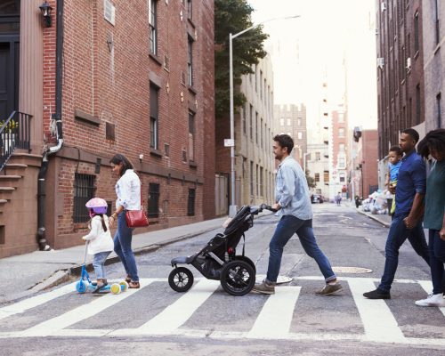 Two families with daughters crossing road Two families with daughters crossing road